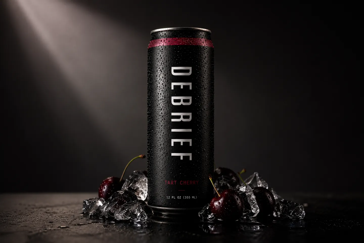 DEBRIEF Tart Cherry can surrounded by dark cherries and ice, lit by a single shaft of light